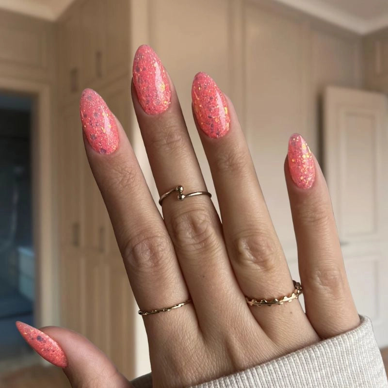 Bright Pink Orange Dip Powder Nails showcasing a bold pink-orange manicure with chunky glitter.