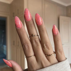 Bright Pink Orange Dip Powder Nails showcasing a bold pink-orange manicure with chunky glitter.