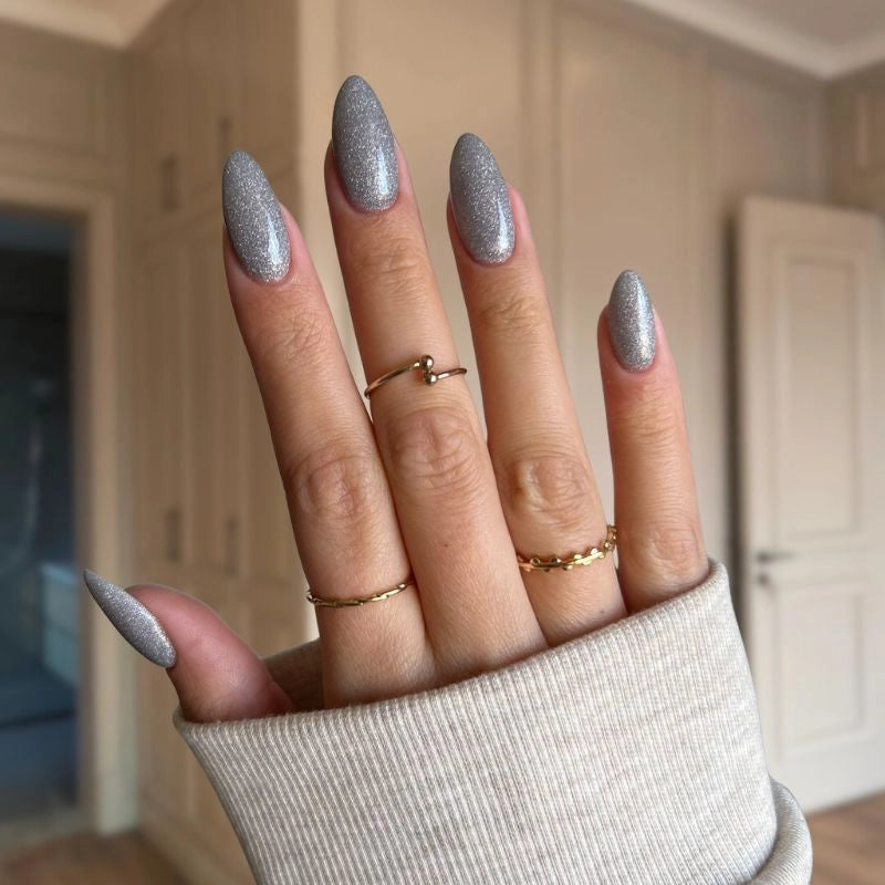 Close-up view of nails coated with Radiant Silver dip powder, highlighting the sparkling glitter for a glamorous look.