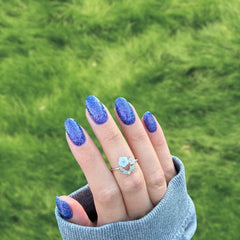 Iris Blue Dip Powder For Nails with vibrant blue tones and subtle purple undertones, offering a shimmering, cool finish.