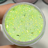 Aurora Stardust dip powder in pastel green with layered shimmer