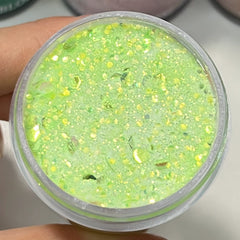 Aurora Stardust dip powder in pastel green with layered shimmer