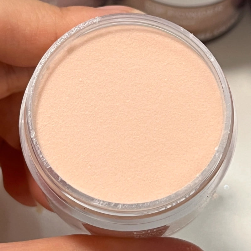 Caramel Clay dip powder in open container with warm tones