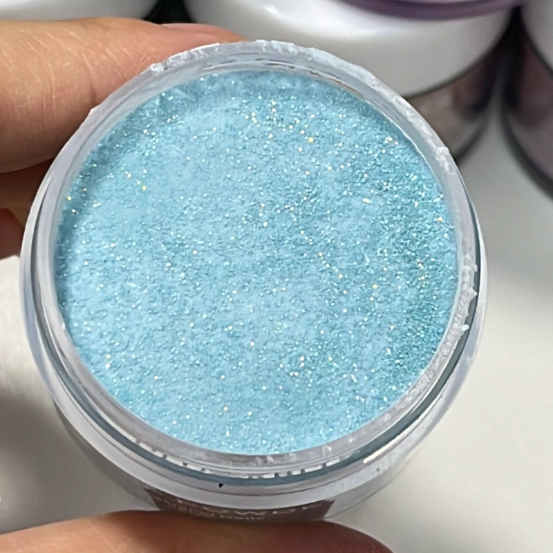 Shimmering sky blue dip nails created with Crystal Blue powder