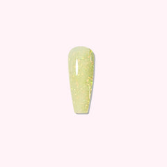 Golden Dusk dip powder applied on nails, showing soft yellow with scattered gold glitter
