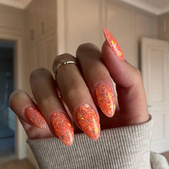 DIY manicure with Mango Orange with Flakes Dip Powder For Nails giving a sparkling, salon-quality look at home.