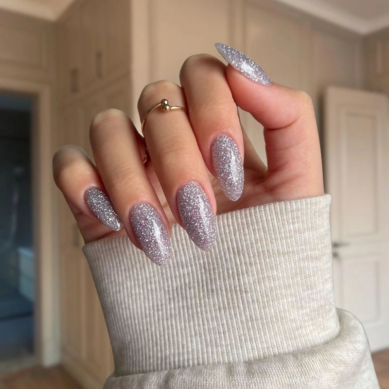 Mesmerizing Silver Dip Powder – A sparkling silver base that transforms with a purple hue in sunlight.