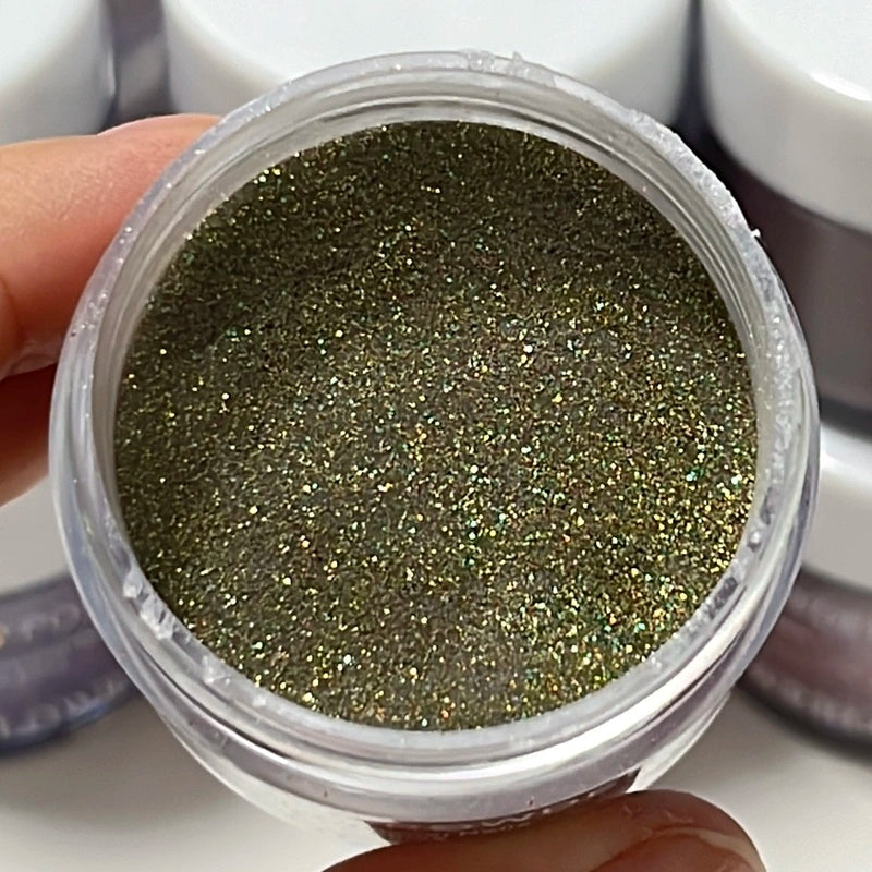 Sparkly olive green dip powder with golden shimmer