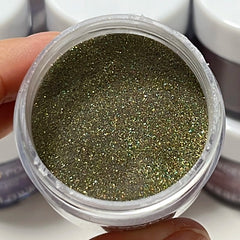 Sparkly olive green dip powder with golden shimmer