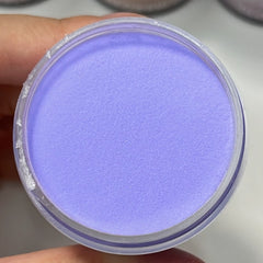 Open jar of Periwinkle Dream dip powder with blue-purple tone