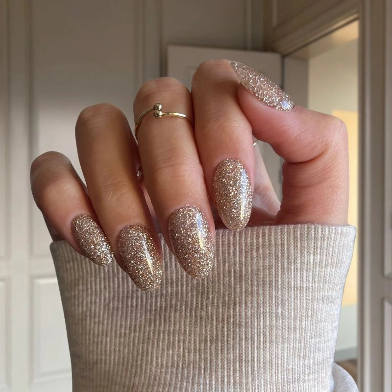 Silver Thistle nails with gold sparkle creating a shimmering, elegant finish with a subtle metallic glow.