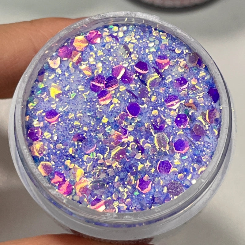 Twilight Stardust dip powder in deep blue with purple tones and multi-size glitter