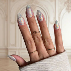 White nails with sparkling glitter and a soft milky tint for a refined, dreamy look.