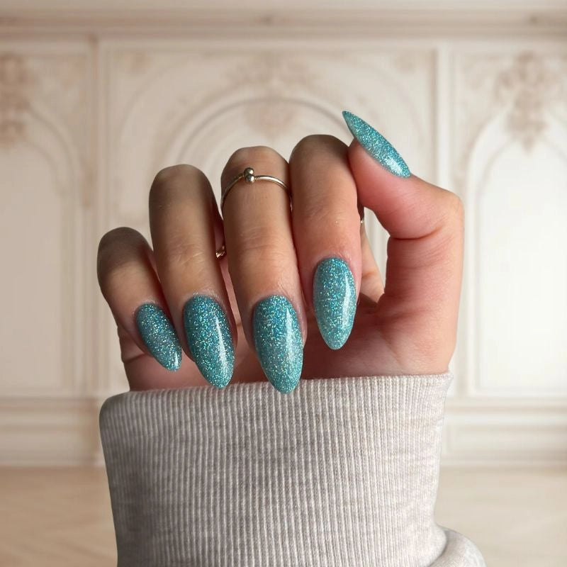 Aqua Blue Dip Powder For Nails showcasing a shimmering light blue manicure with a tropical vibe.