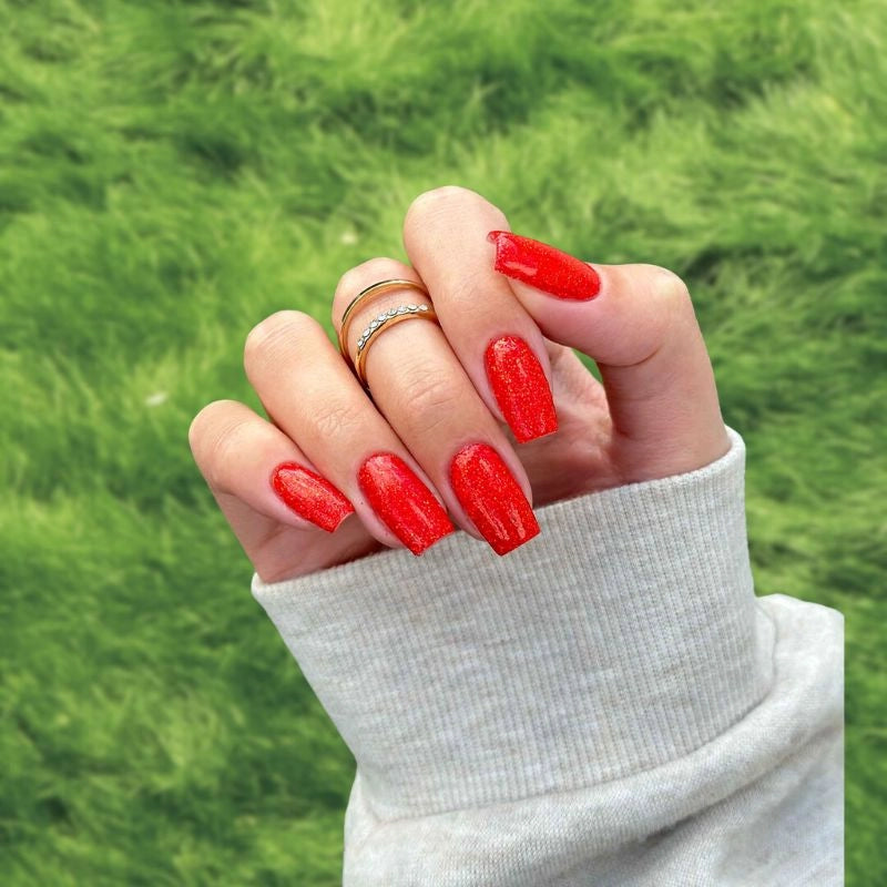Dazzling Red Dip Powder Nails for a sparkling red pedicure.