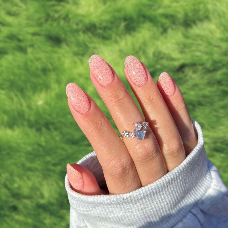 Soft Sunset Orange Dip Powder Nails showing warm tones and speckled design.