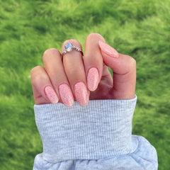 Soft Sunset Orange Dip Powder Nails for a unique orange pedicure with speckled finish.