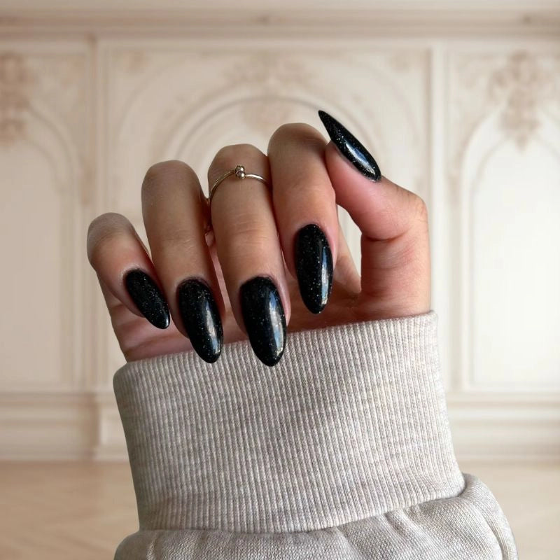 DIY manicure using Black with Fine Sparkle Dip Powder For Nails creating an elegant, sparkly finish at home.