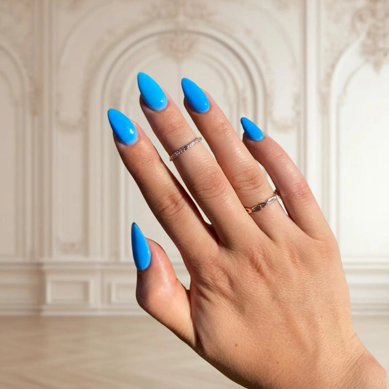 DIY manicure using Bright Blue Dip Powder For Nails for a bold, salon-quality finish at home.