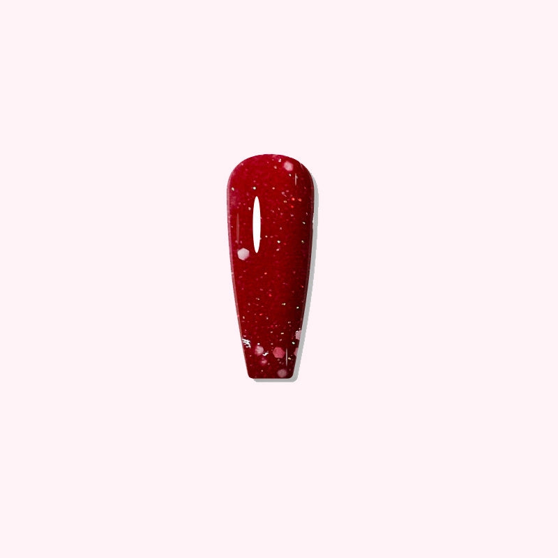 Festive Scarlet dip powder applied on nails, showing vibrant red with subtle white glitter
