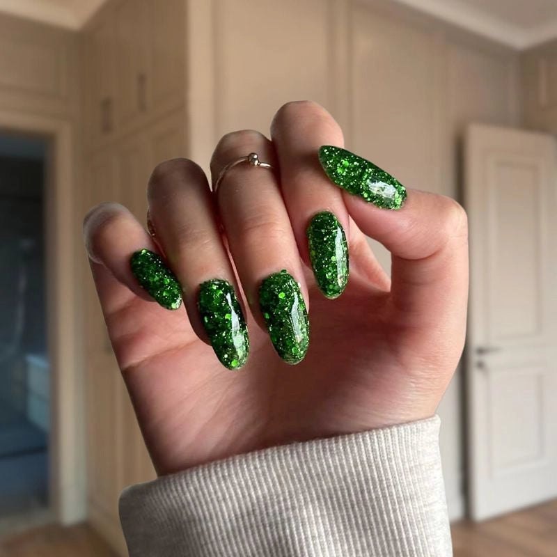 DIY manicure using Christmas Green with Glitter Dip Powder For Nails for a sparkling, festive look at home.