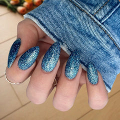 DIY manicure using Denim Blue with Sparkle Dip Powder For Nails for a stunning, customizable finish at home.