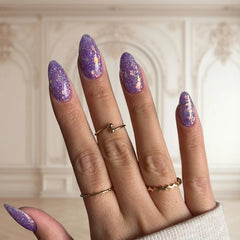 Dreamy Purple nails with abundant glitter creating a magical, sparkling finish.