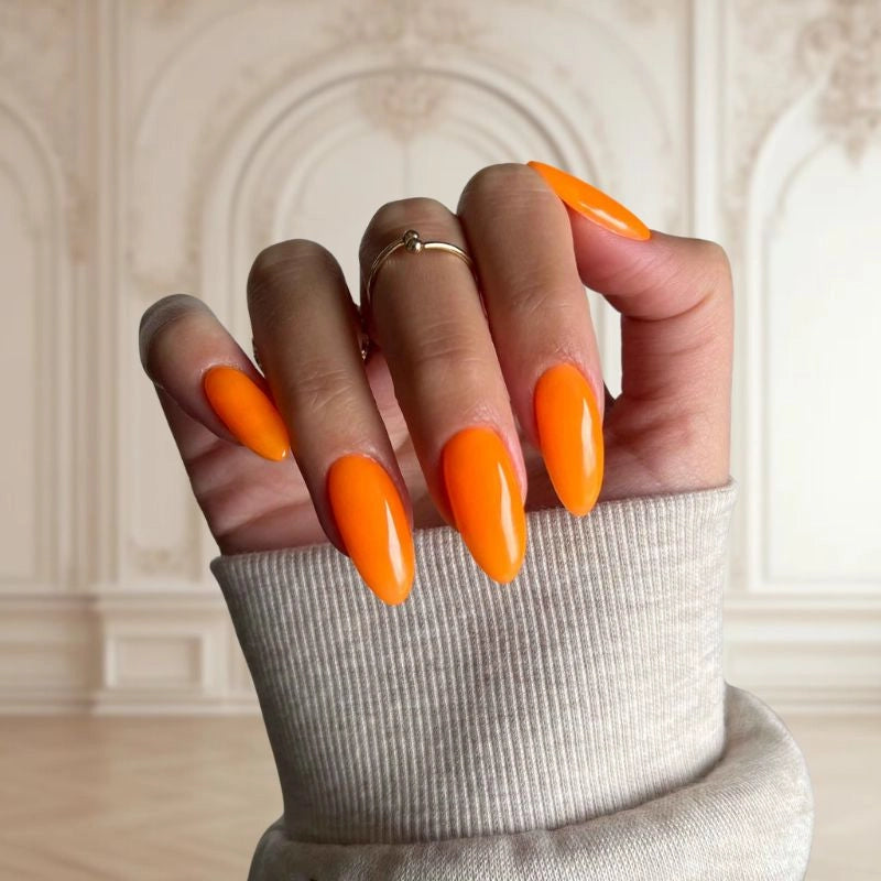 Neon Orange nails creating a bold and vibrant DIY manicure finish.