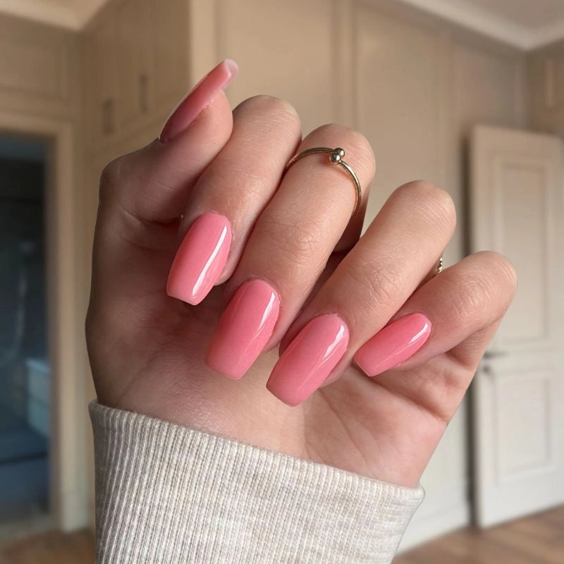 Peachy Pink nails offering a soft, feminine look with a glossy, professional finish.