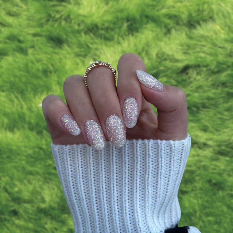 Swatch of Pearl Glow Dip Powder for Nails with a soft white base and shimmering pearl-like glitter.