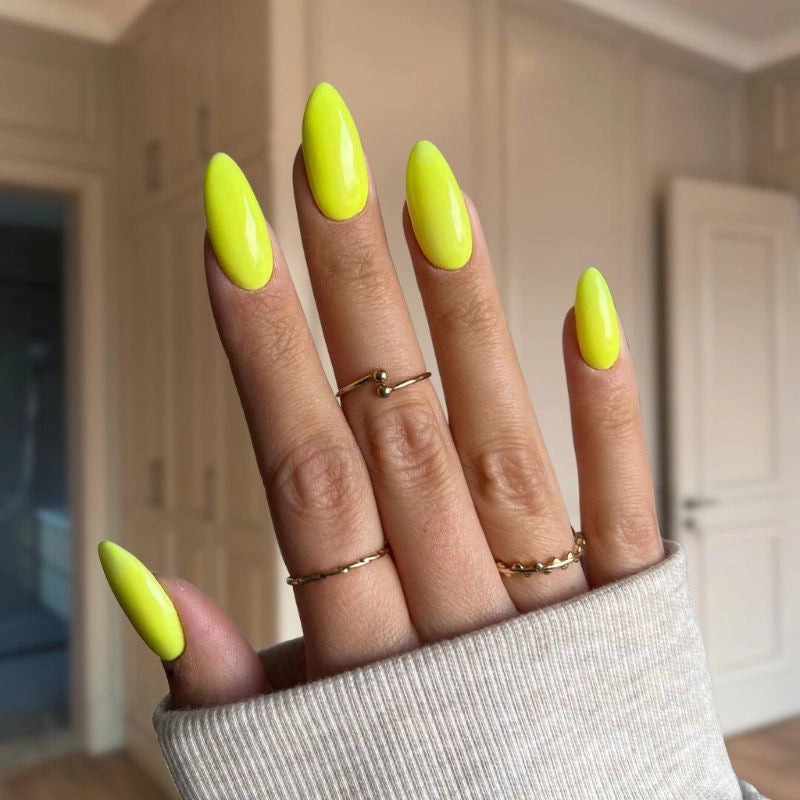  Bold, energetic yellow nails showcasing a glossy, professional at-home finish.